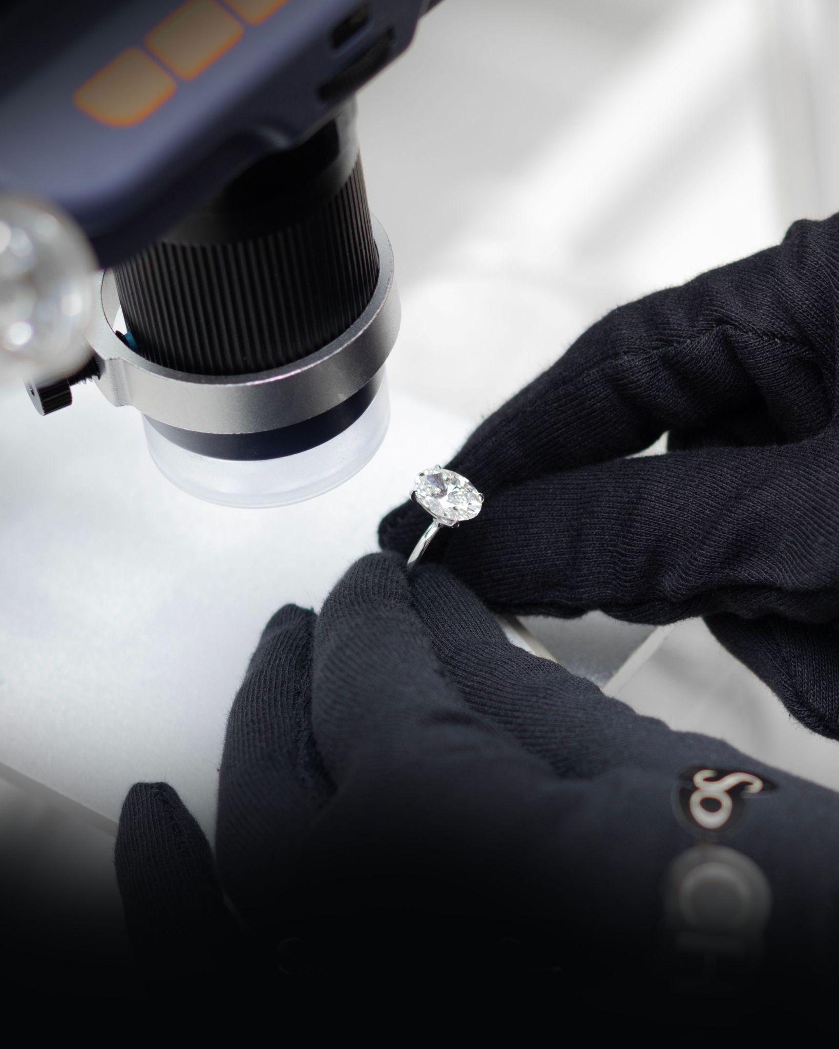 Jeweler examining a loose diamond with a loupe
